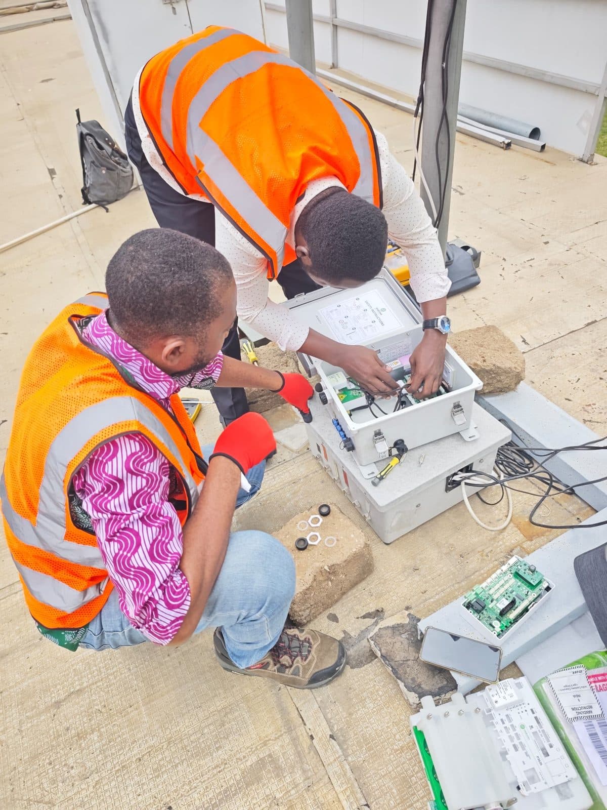 ECHT technicians working on a monitoring station enclosure